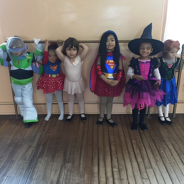 Children in various costumes standing together.